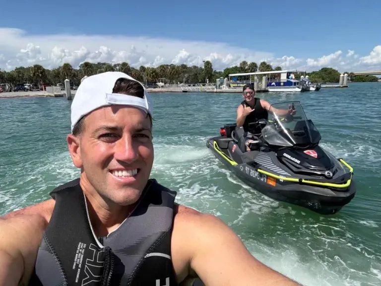 Steve Matheson (right) on a jet ski behind another person on a jet ski.