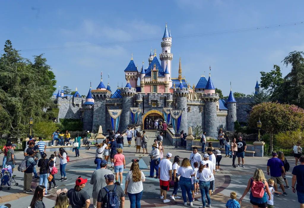 Visitors stand in front of Sleeping Beauty Castle inside Disneyland in Anaheim, California.