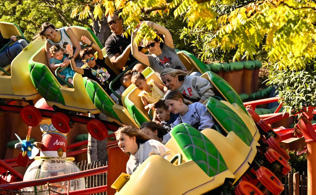Visitors on Chip 'n' Dale's GADGETcoaster inside Disneyland.