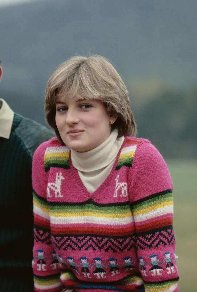 Lady Diana Spencer in a pink and rainbow striped sweater with llama patterns.