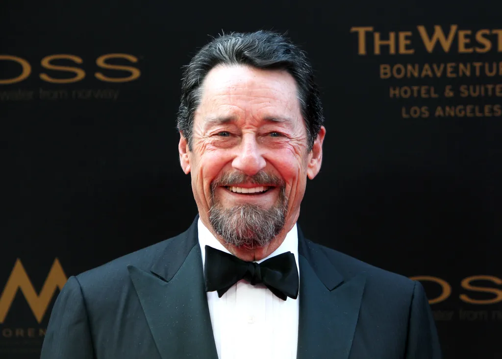 Voice actor Peter Cullen smiling in a tuxedo.