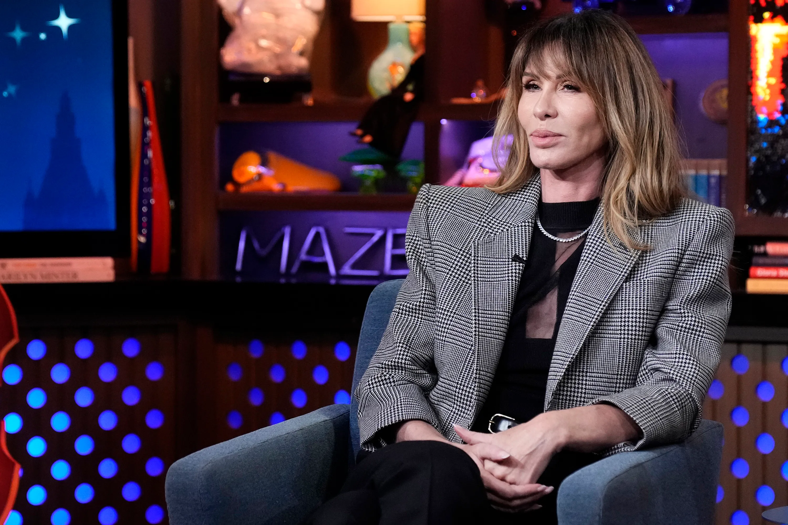 Carole Radziwill in a black and white plaid blazer and black top.