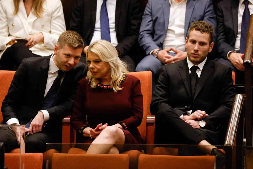 Sara Netanyahu sits with her sons, Avner and Yair, in the Knesset during the swearing-in of Israel's new government.