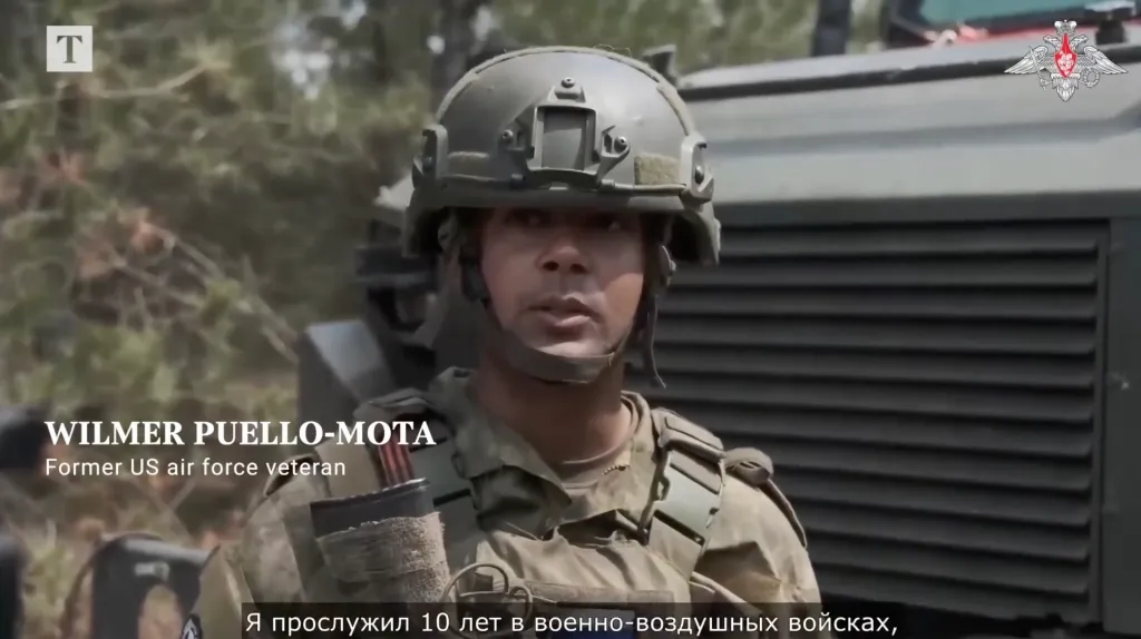 A former U.S. air force veteran, Wilmer Puello-Mota, wearing a military helmet and tactical vest.