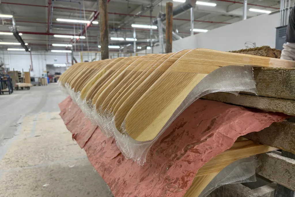 Wooden hockey sticks are stacked as they move along the assembly line at the Roustan Hockey factory on Wednesday, Aug. 27, 2025, in Brantford, Ontario.