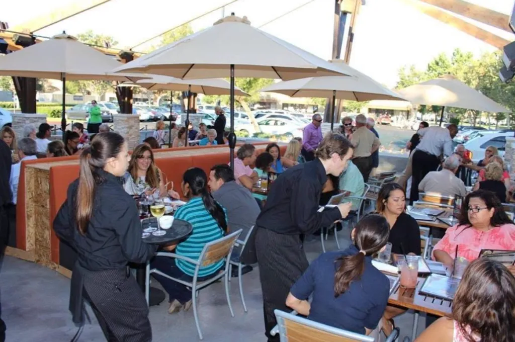 Patrons dining outdoors at Tahoe Joe's Steakhouse.