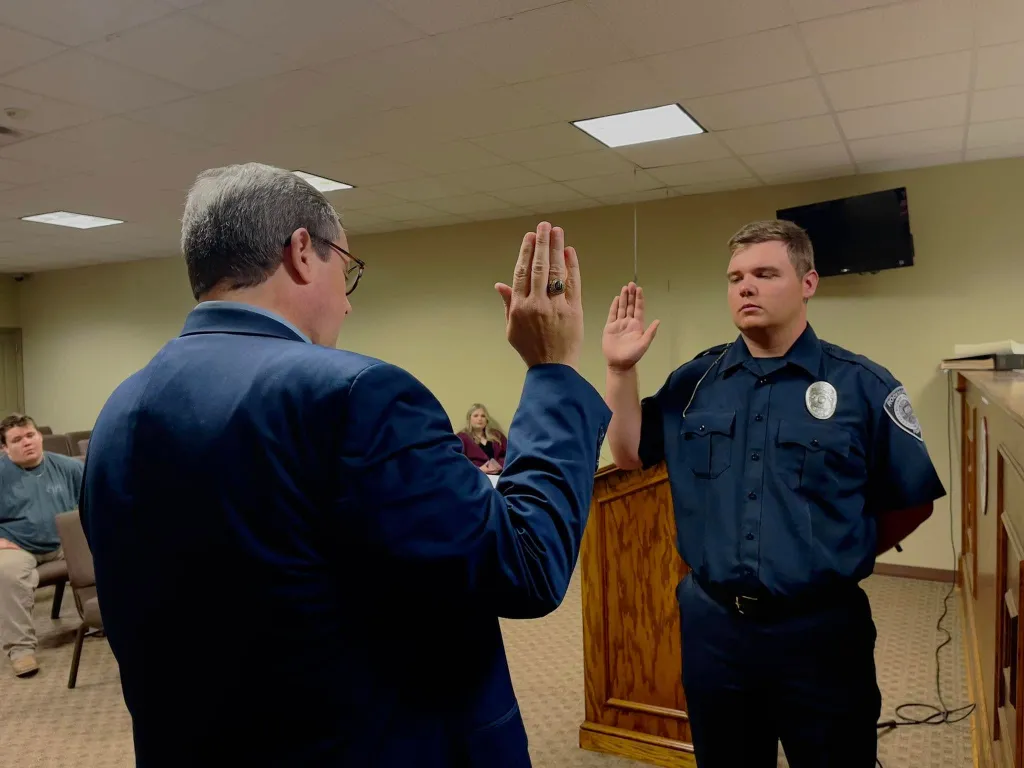 Trenton Garner, accused of killing a baby donkey, is sworn in at a police department ceremony.