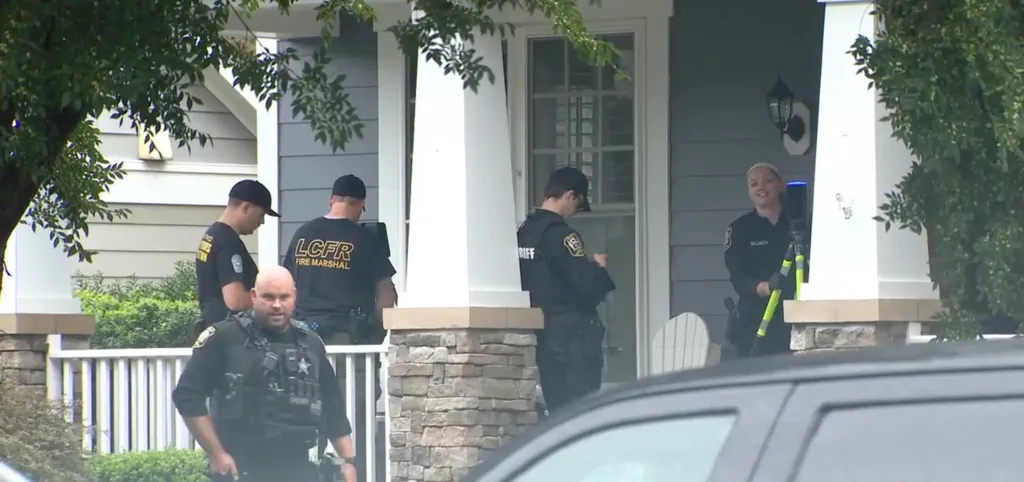 Law enforcement officers and fire marshals at the scene where Lisa Bradford was found dead.