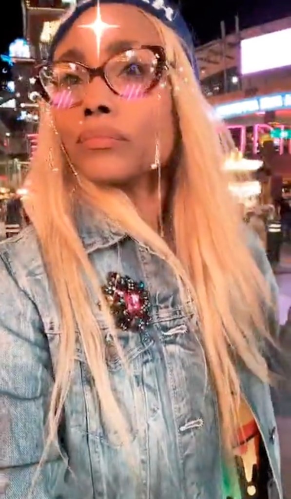 Christy Knowings wearing glasses with a sparkle filter and a bejeweled denim jacket.