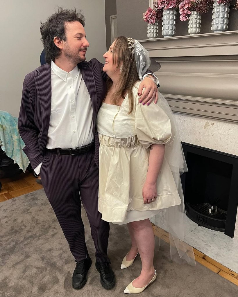 Lena Dunham and husband Luis Felber, smiling and embracing.