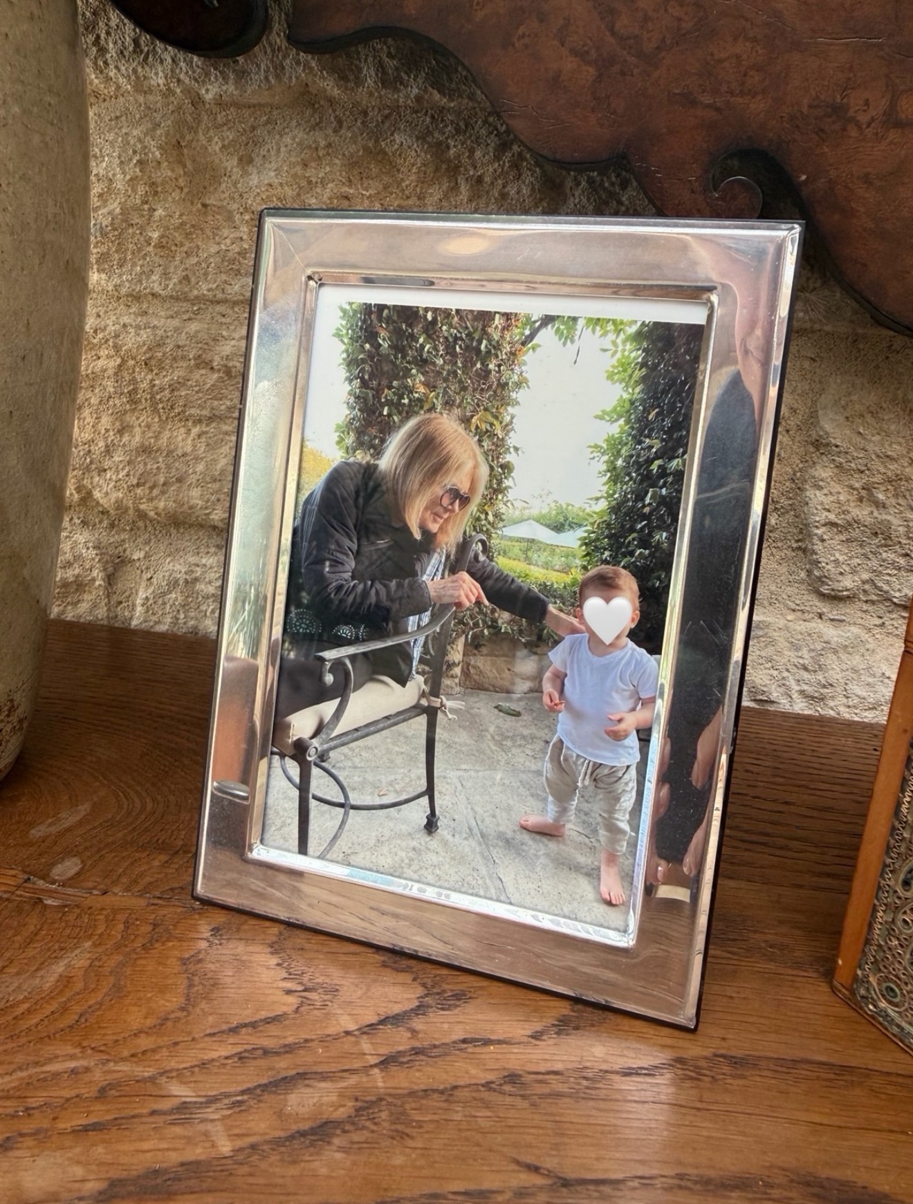Framed photo of Gloria Steinem interacting with a young child.