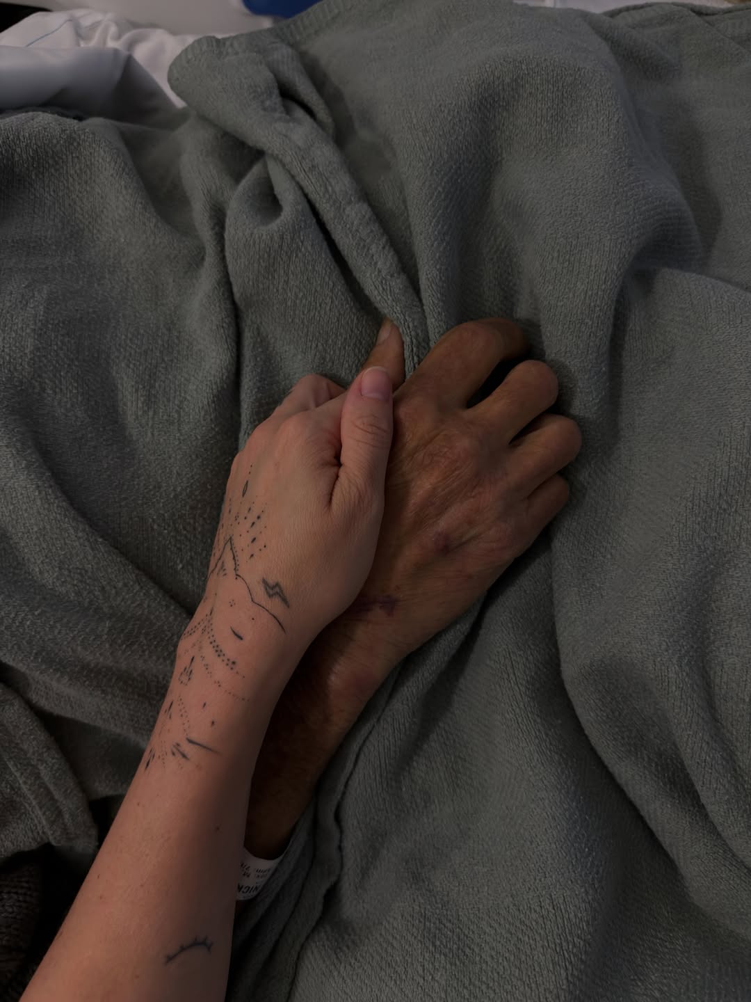 Christopher Nicks and his daughter holding hands. 