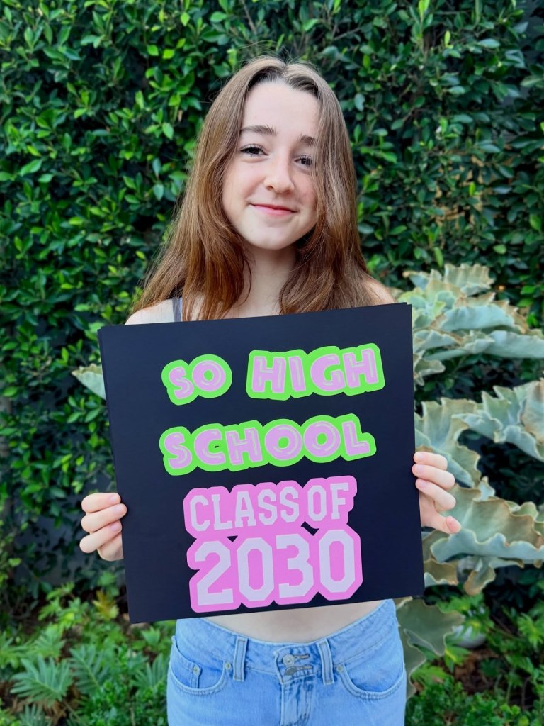 Keeva Hannigan holding a sign that reads 