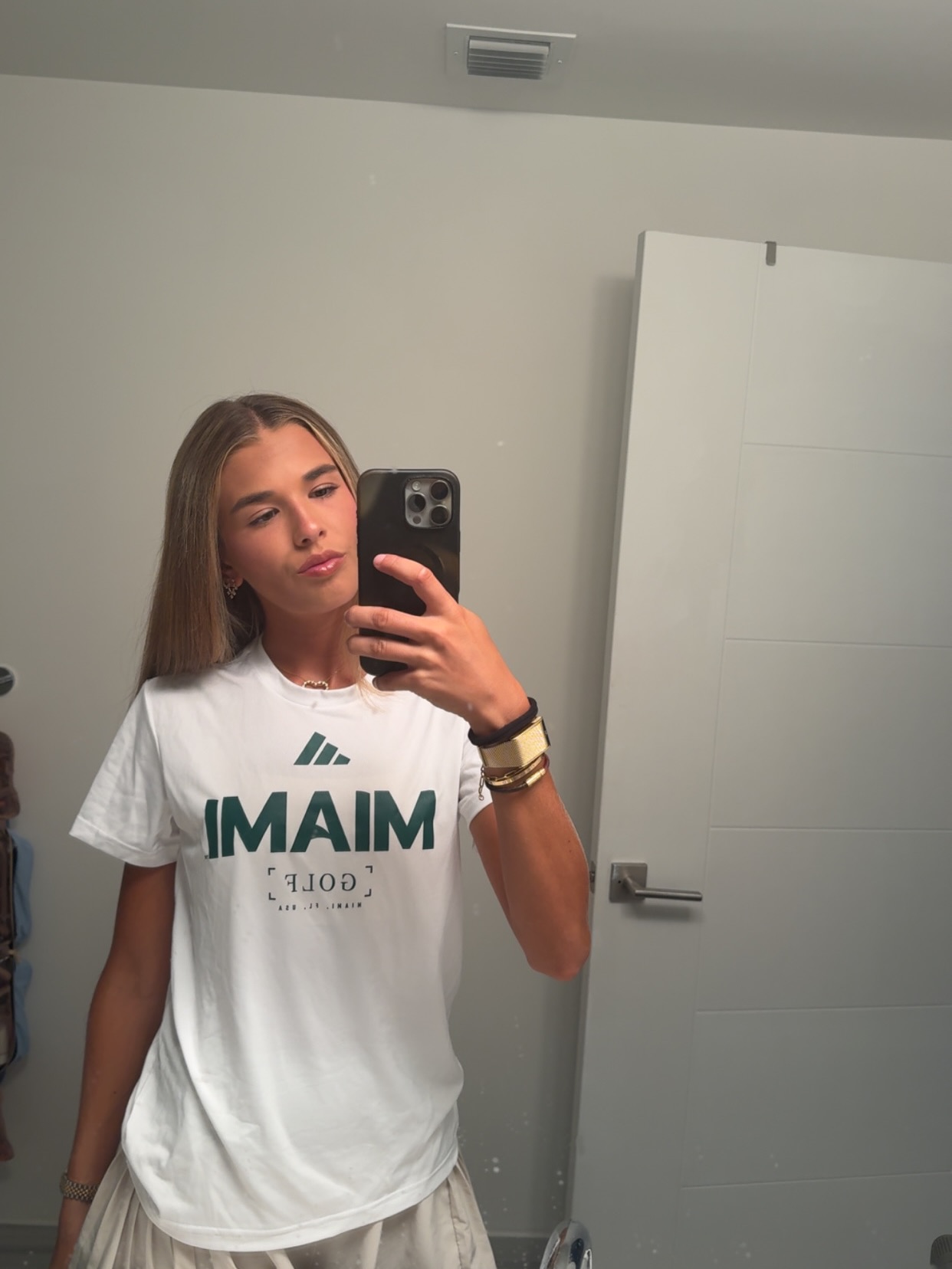 A woman with blonde hair wearing a white