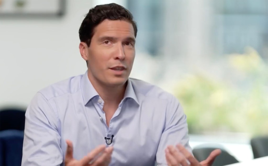 Will Reeve speaking and gesturing with his hands.