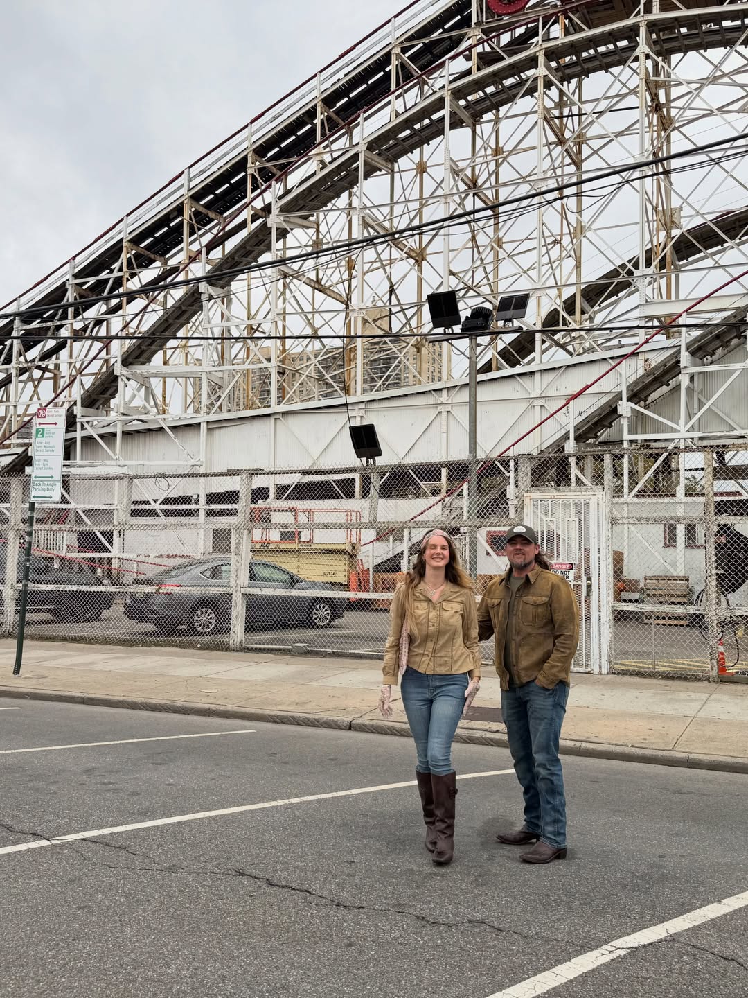 Lana Del Rey and Jeremy Dufrene in front of a roller coaster.