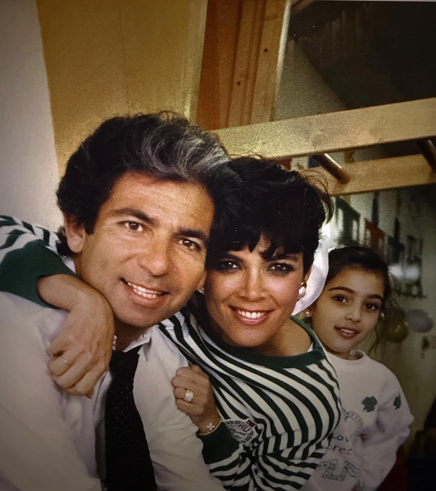 Robert Kardashian, Kris Jenner, and young Kim Kardashian pose for a picture together.