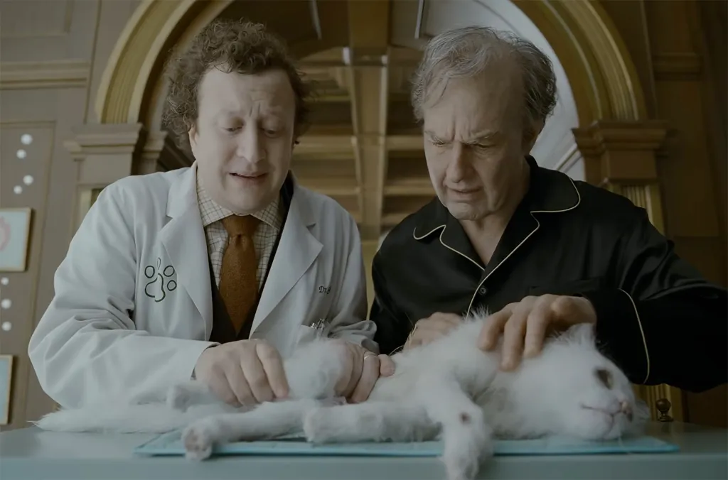 Tom Cruise, in aging make up and black pajamas, and Ross Hatt in a white lab coat.