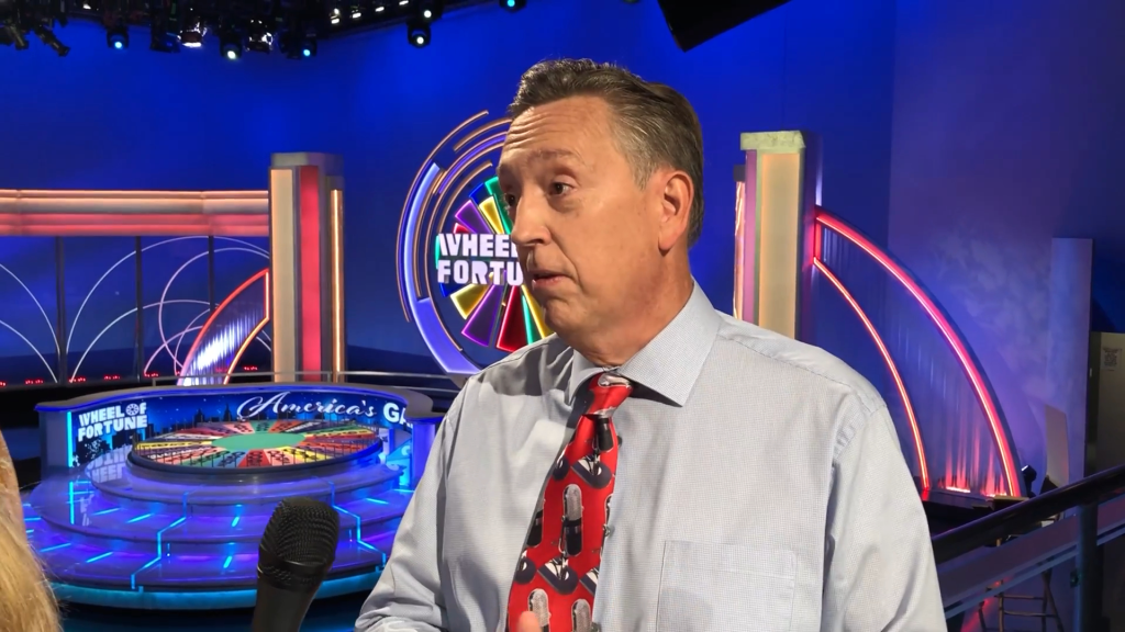 Jim Thornton, the announcer for Wheel of Fortune, on the game show set.