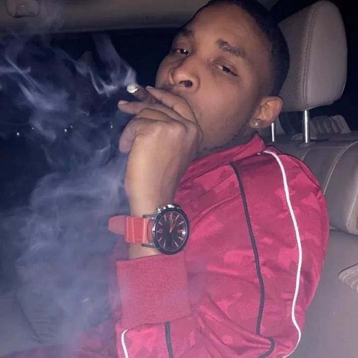 Carlton Johnson, a Minneapolis shooting suspect, smoking.