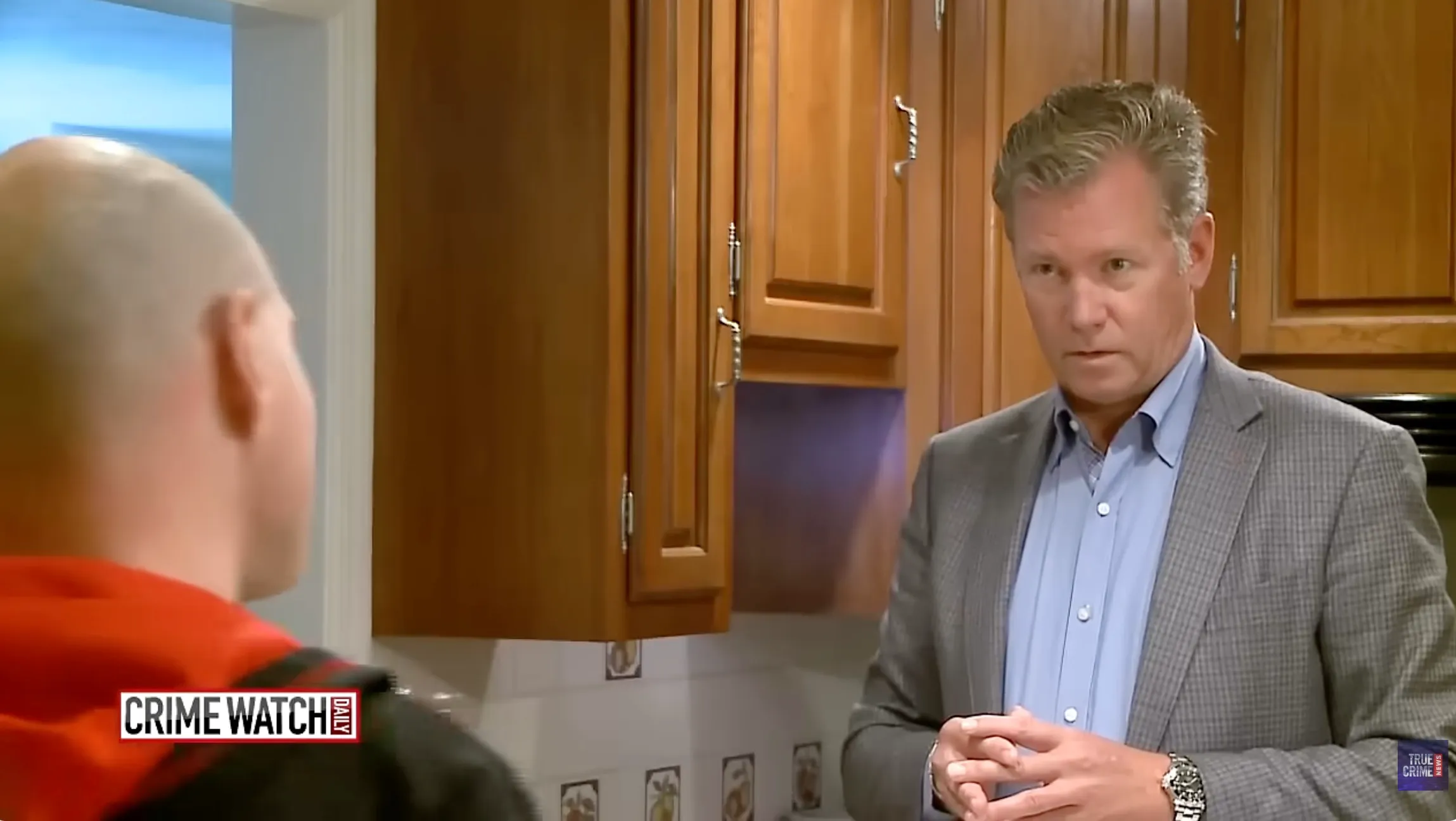 Chris Hansen questioning a person with a bald head.