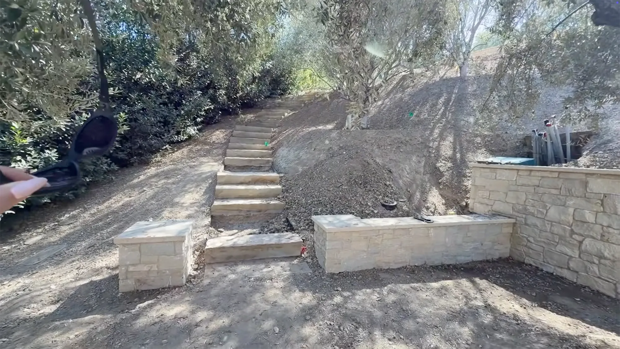 Kylie Jenner's new home under construction with stone steps and retaining walls.