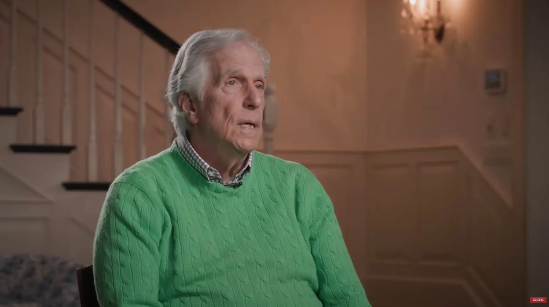 Henry Winkler in a green sweater, discussing his beef with Tom Hanks.