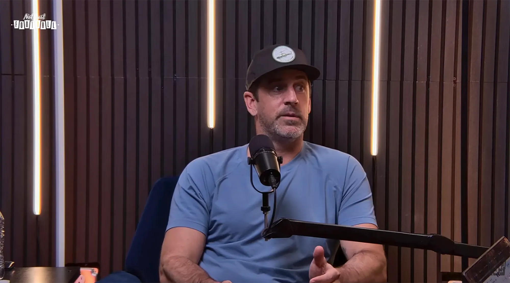 Aaron Rodgers speaking into a microphone.