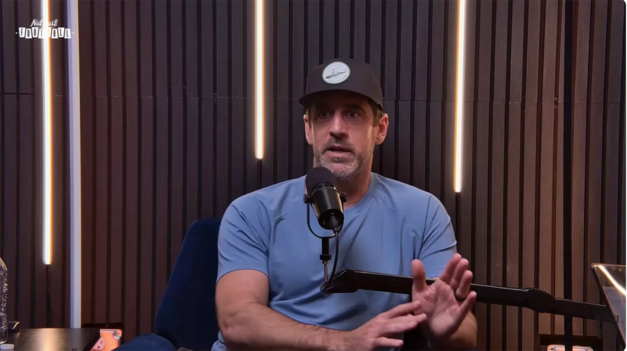 Aaron Rodgers speaking into a microphone.