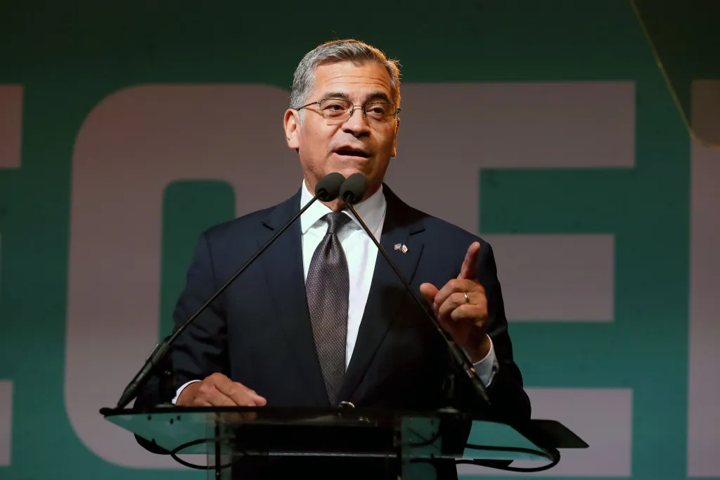 Xavier Becerra speaks at a podium during an election night party.