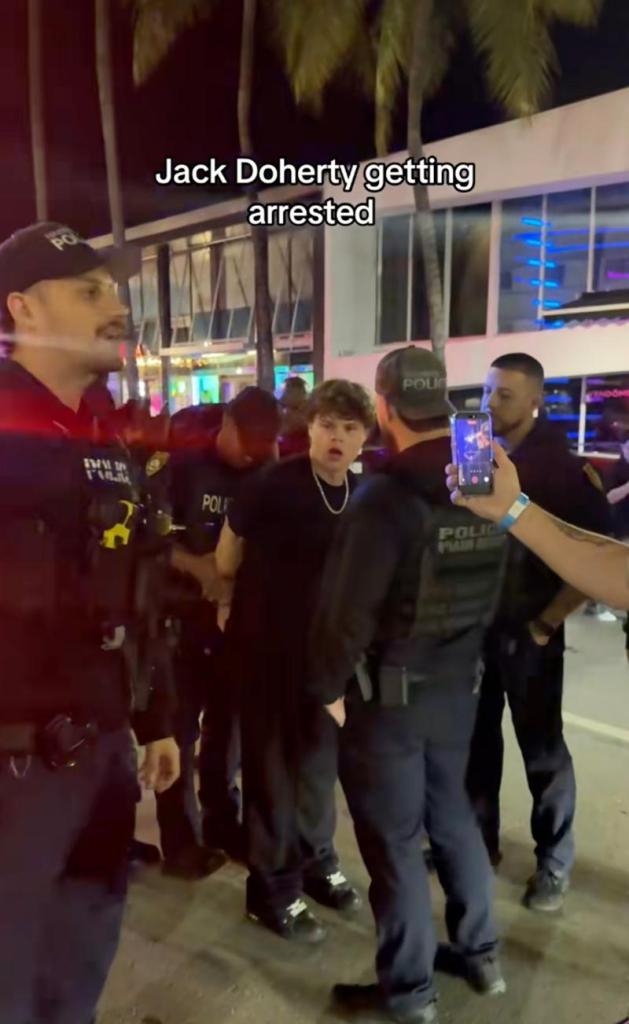 Jack Doherty being arrested by police officers.