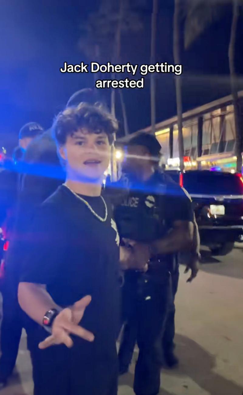 Jack Doherty appearing to be arrested by police officers.