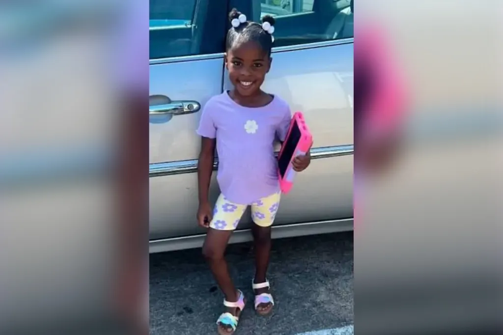 Zah'Layah Walter, 5, smiling and holding a pink tablet.