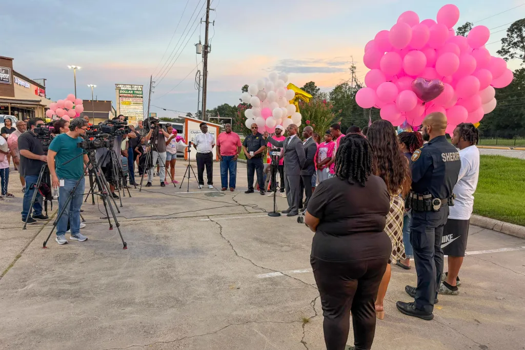 A group of people, including journalists and community members, gather for a press conference to remember 5-year-old Zah'Layah Walter.