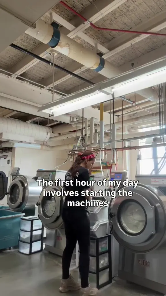 Zoe De La Paz starting laundry machines.