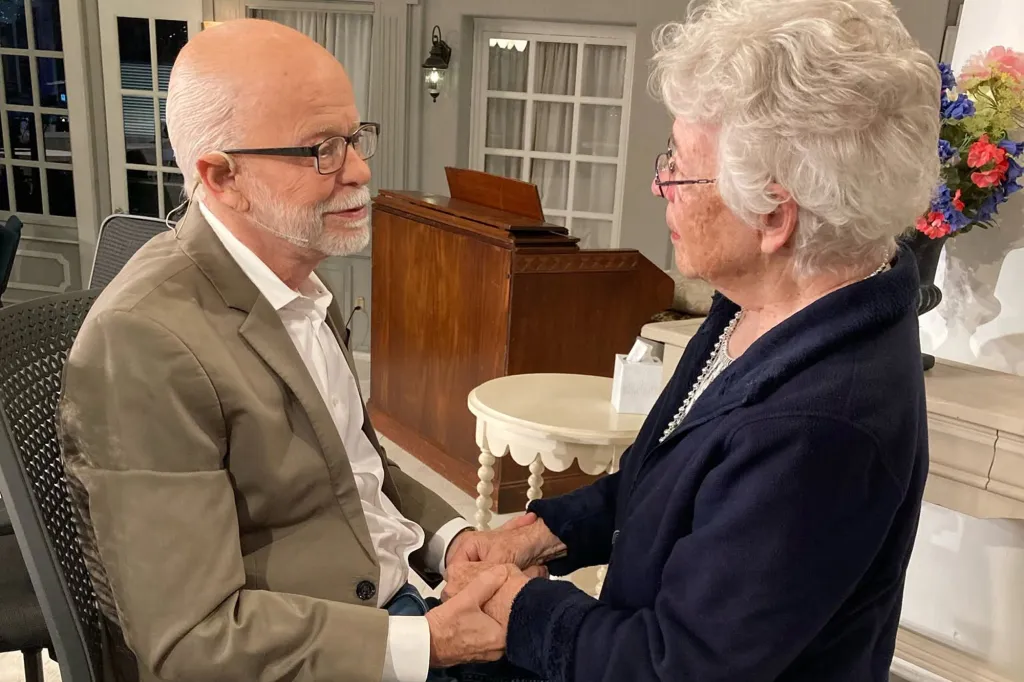 Jim Bakker holds hands with his sister, Donna Puckett.