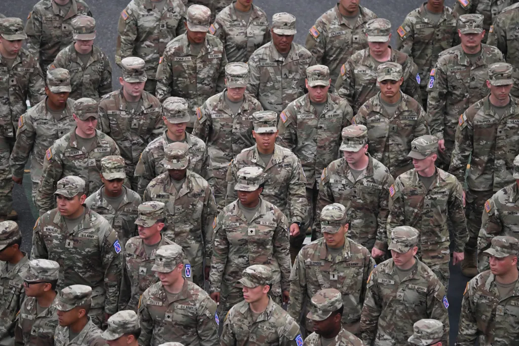 U.S. Army Mountain division combat soldiers march in formation during a parade.