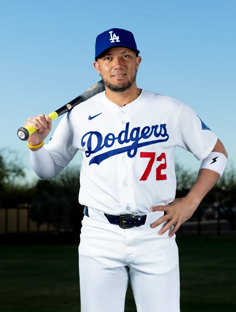 Los Angeles Dodgers player holding a baseball bat during spring training at Camelback Ranch.