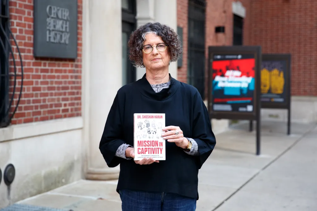 Shoshan Haran holding her book titled 