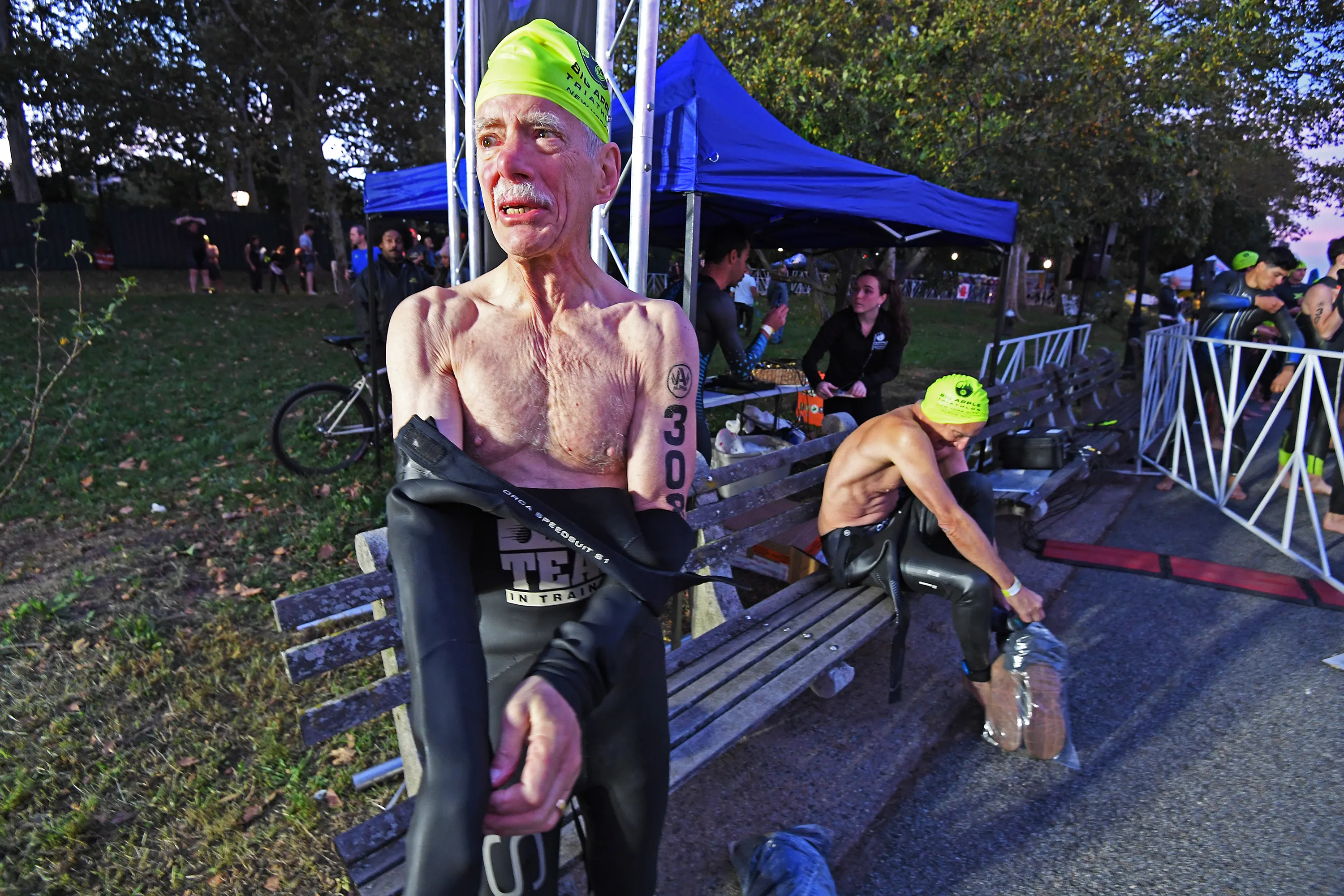 Competitors prepare for the NYC Triathlon near the starting line.