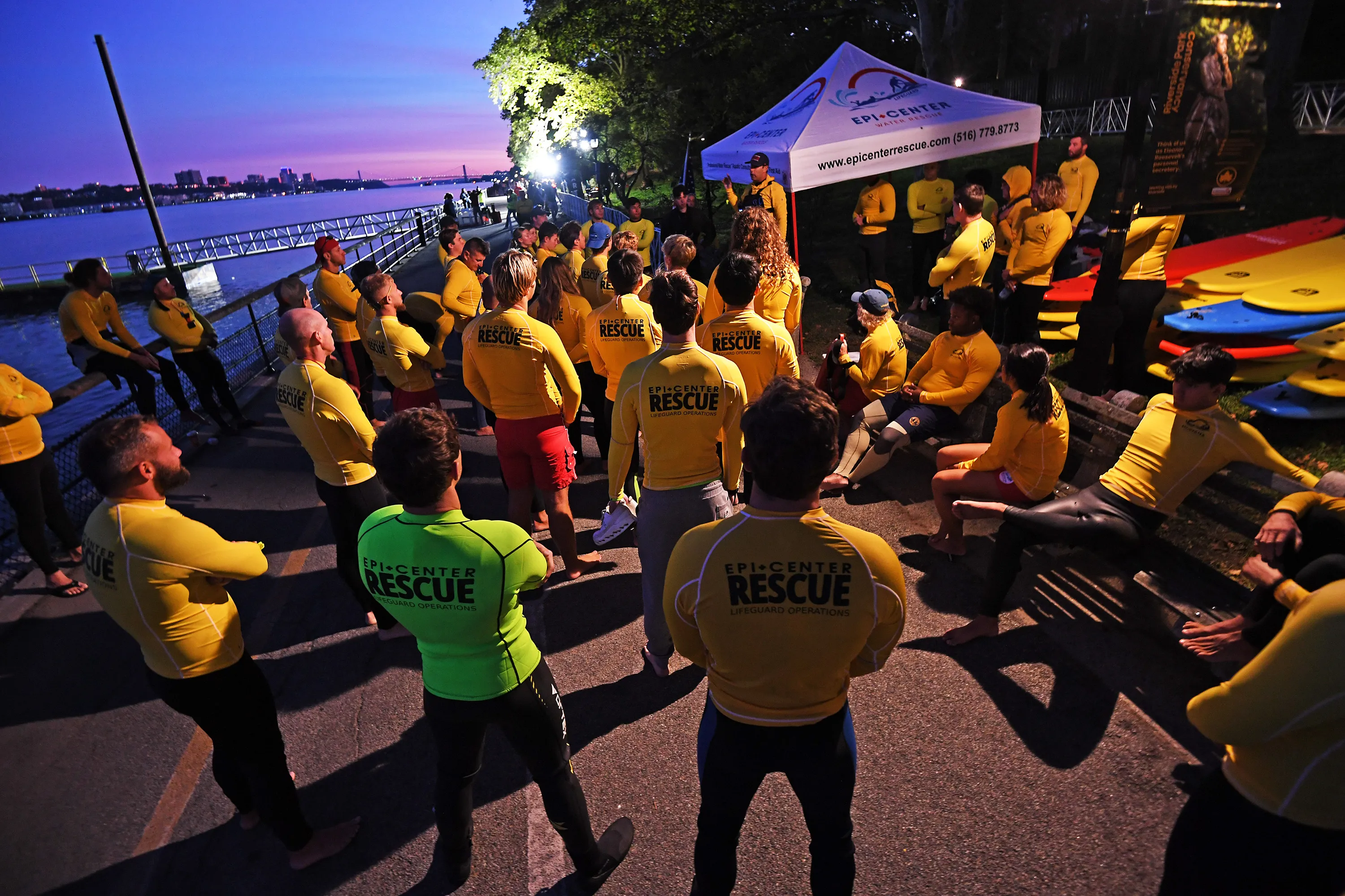 Competitors in the NYC Triathlon gather at the starting line alongside the Hudson River.