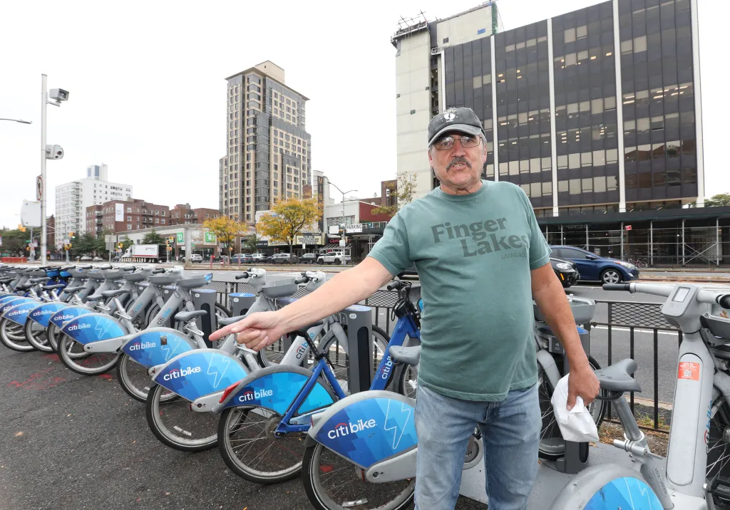Joe Angello, 70, of Queens, stands at a Citi Bike station at Queens Boulevard and 71st Avenue in the Forest Hills neighborhood of Queens, New York, Saturday, Aug. 15, 2026.