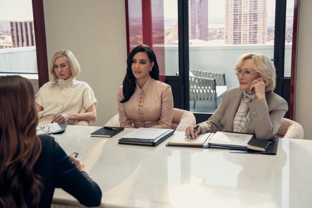 Naomi Watts, Kim Kardashian, and Glenn Close sit in a boardroom with documents and notepads.