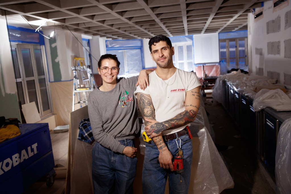Proprietors Moe Aljaff and Juliette Larrouy stand inside the new bar Schmuck under construction in Manhattan.