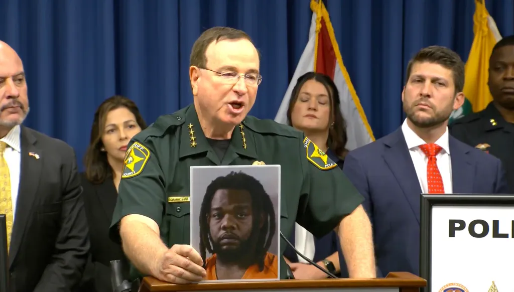 Polk County Sheriff Grady Judd holds a photo of suspected sex criminal