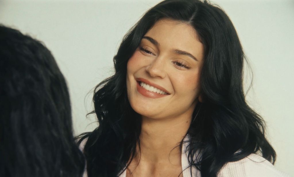 Kylie Jenner smiling and looking off-camera.