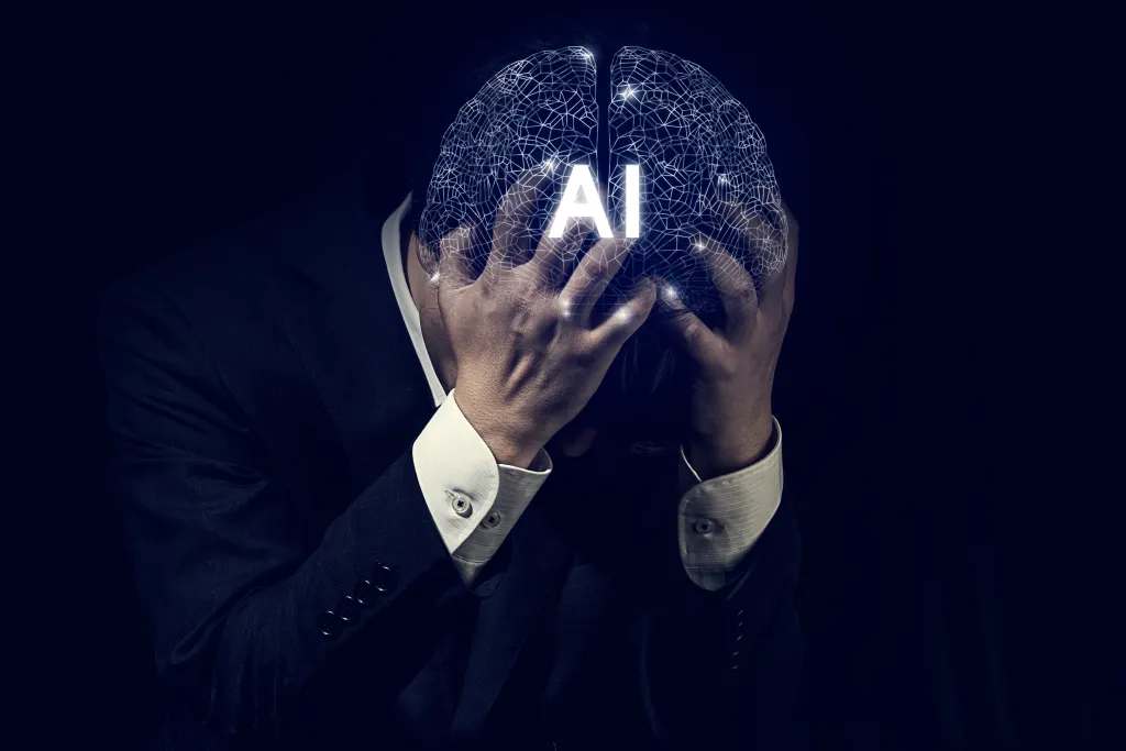 A distressed businessman in a suit holds his head in his hands, with a glowing digital wireframe brain graphic labeled