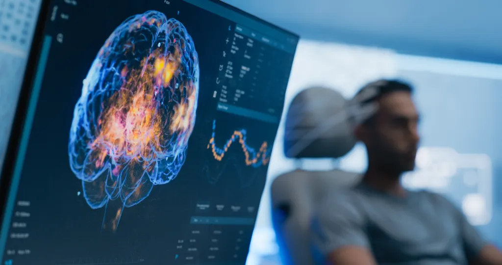 A scan of a brain and a man in a doctor's chair