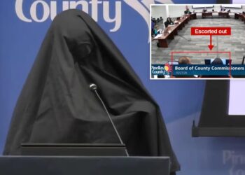 Woman wearing burka escorted out of Florida county meeting after playing call to prayer recording