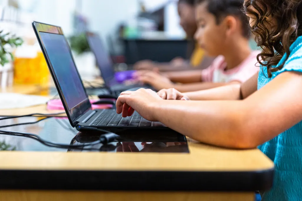 Elementary students learn in a computer lab with their teacher on Monday, June 9, 2025.